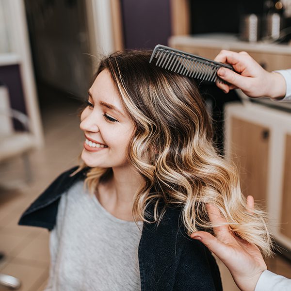 Young woman after dyeing hair and making highlights in hair salon.